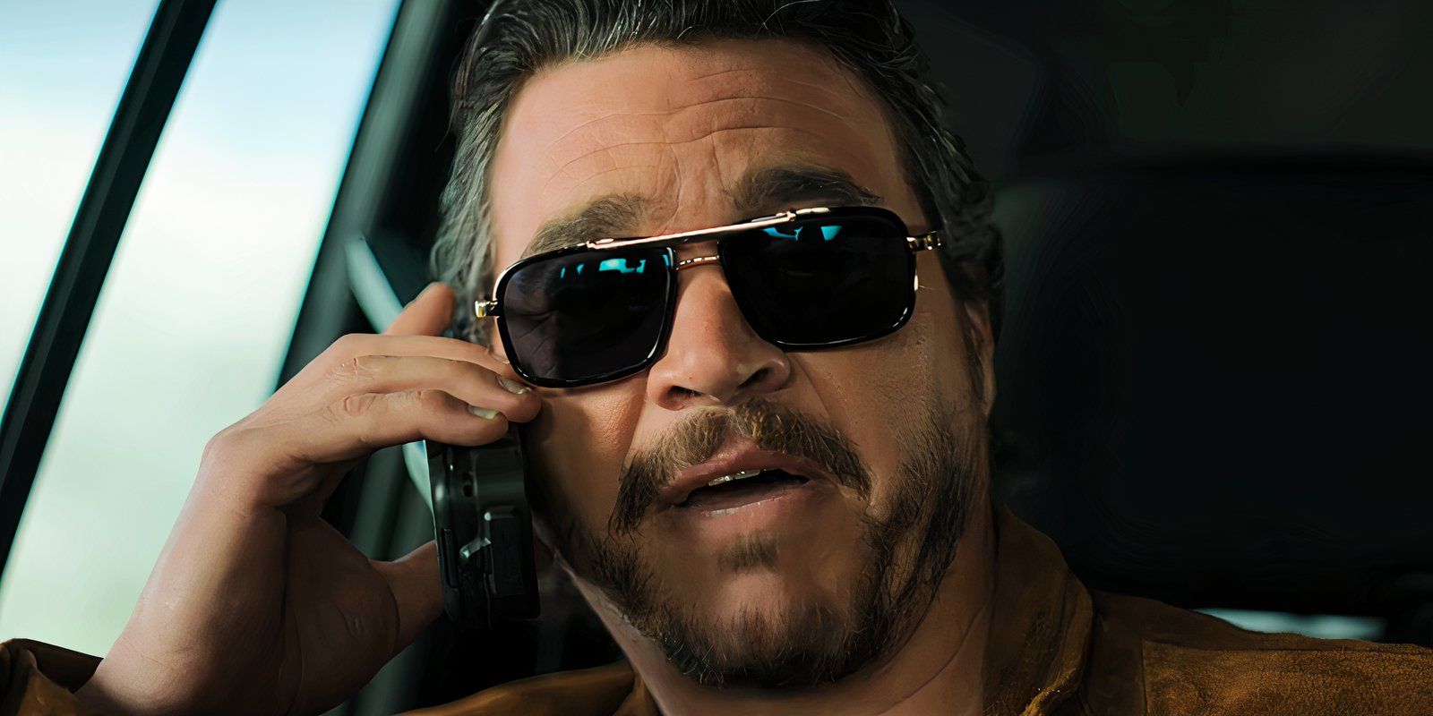 Hector Moya wears sunglasses and talks on the phone in The Lincoln Lawyer Season 3