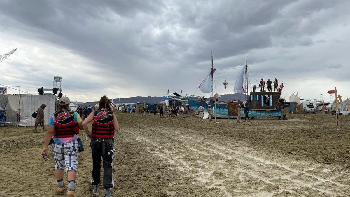 People walk around the Burning Man Festival in 2023